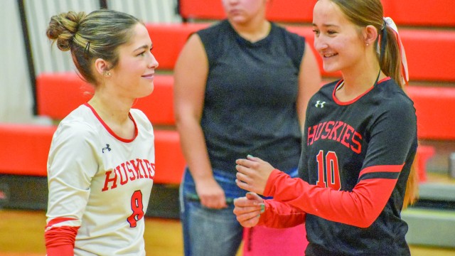 Kate Preator and Rae Leonhardt celebrate a good pass in the home game against Dubois. Stephanie Tolman