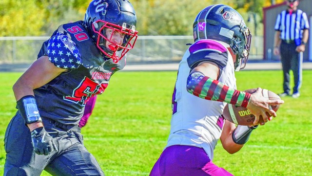 Riverside High School’s Corbyn Godfrey locks in on Midwest’s Noah Dickerson moments before the tackle during last Friday’s varsity game in Basin. Lisa Kunkel