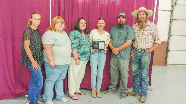 Big Horn County Fair Board members recognize Reece Allen with a plaque. Reece won the fairbook front cover contest for the second year in a row. Barbara Anne Greene